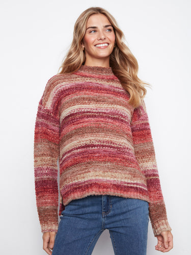 Striped sweater with a cozy mock neckline, perfect for chilly days. The blend of warm hues adds a touch of elegance by Charlie B.