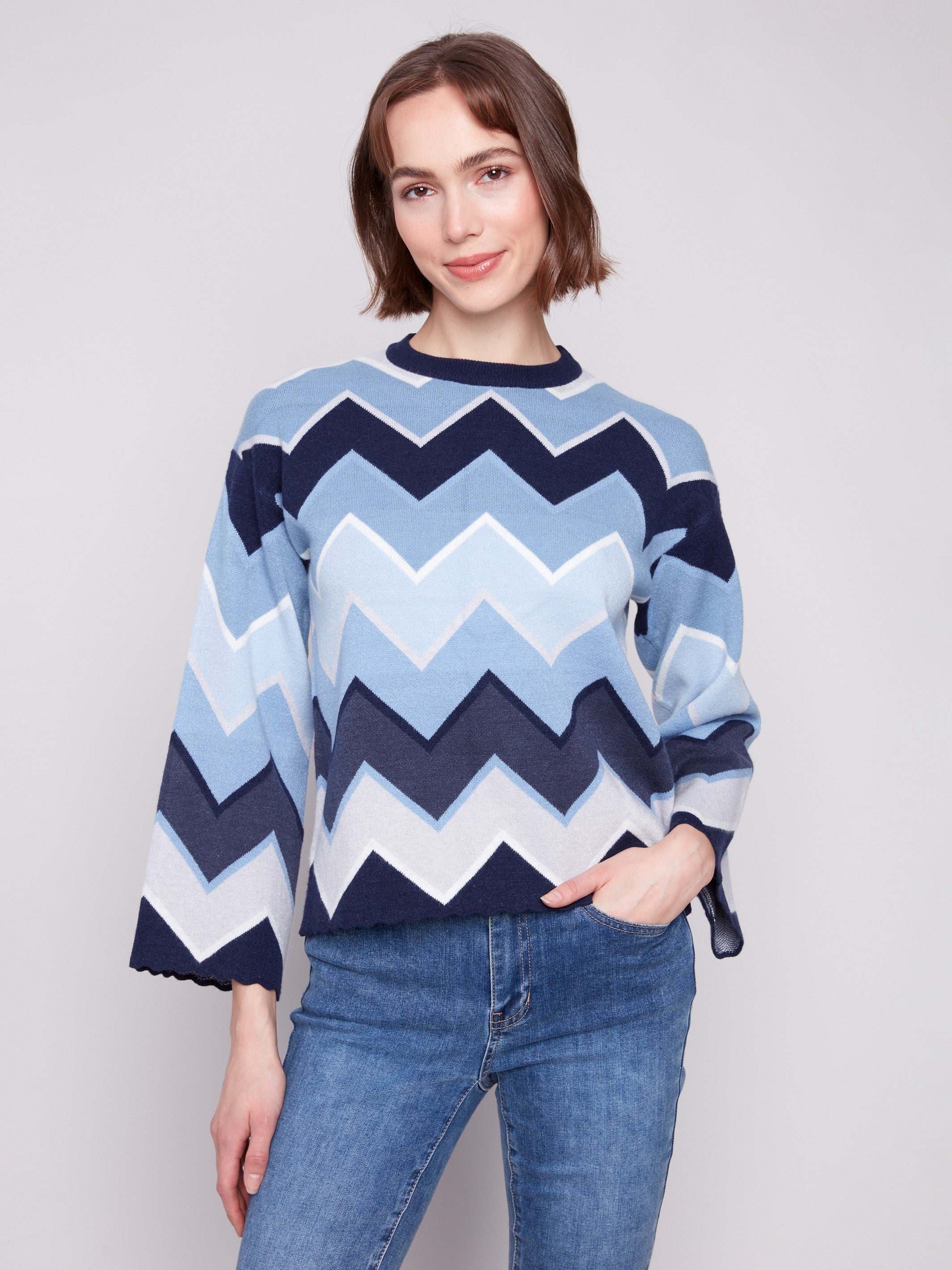 Stylish blue sweater featuring a chevron pattern and chic bell sleeves, perfect for any occasion by Charlie B.