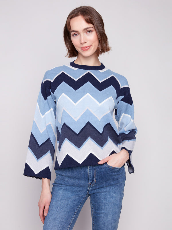 Stylish blue sweater featuring a chevron pattern and chic bell sleeves, perfect for any occasion by Charlie B.