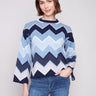 Stylish blue sweater featuring a chevron pattern and chic bell sleeves, perfect for any occasion by Charlie B.