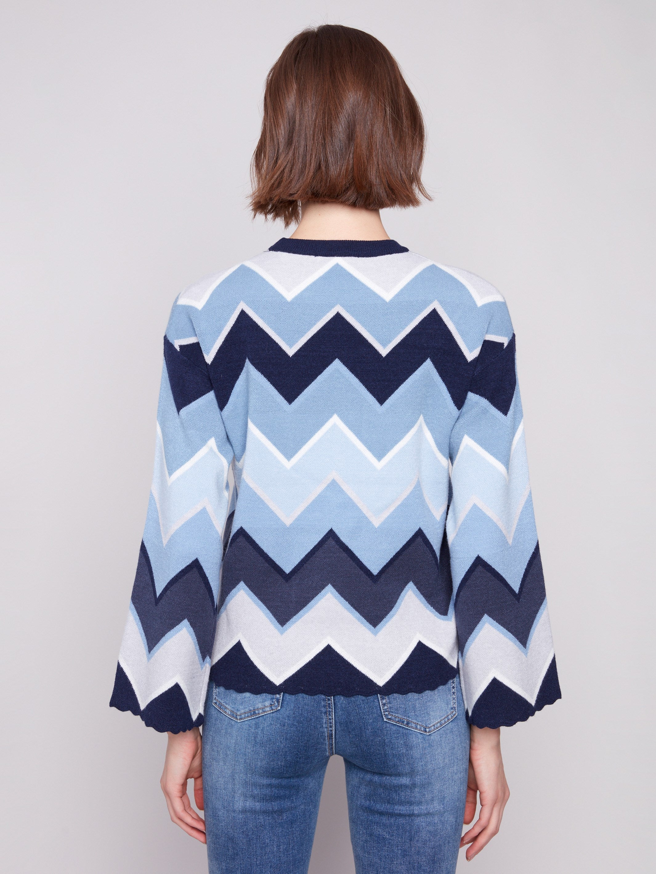 Chic blue chevron patterned sweater with trendy bell sleeves, offering both style and comfort by Charlie B.