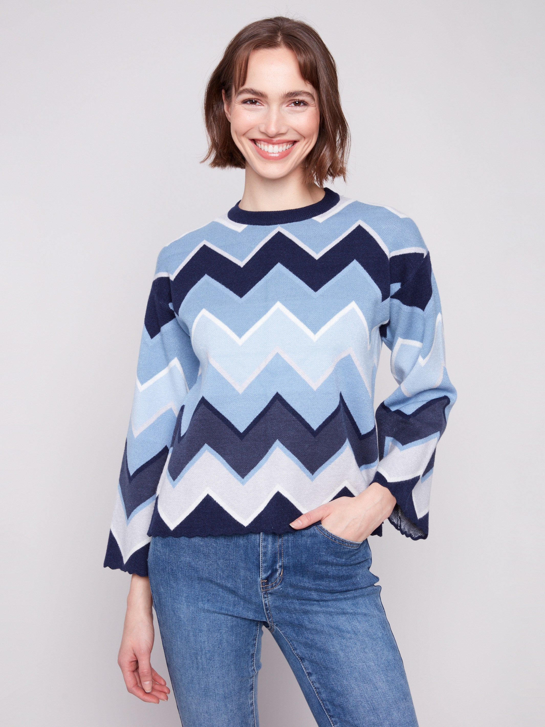 Blue sweater with classic crew neckline and bold chevron pattern for a modern look by Charlie B.