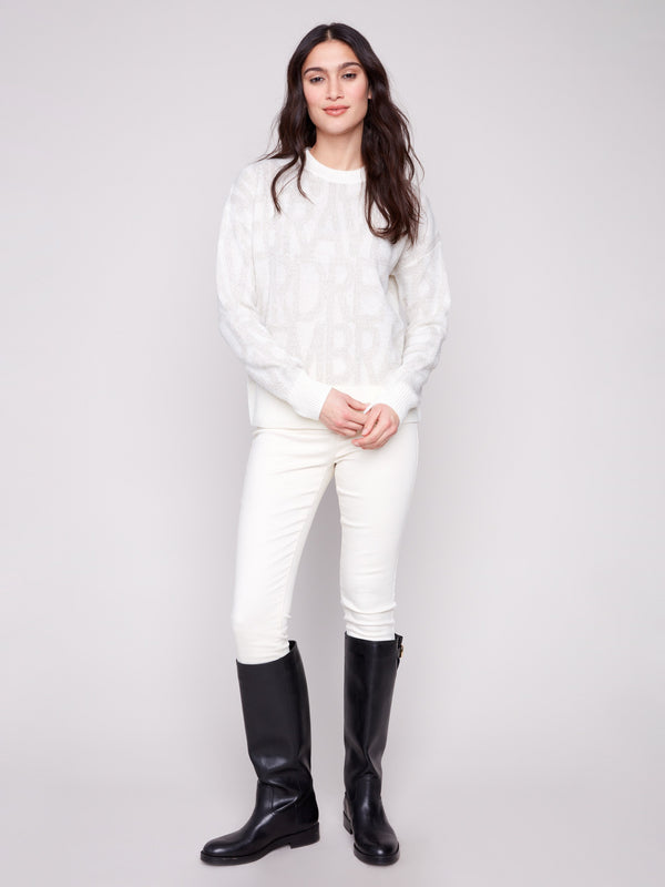 Sophisticated off-white sweater with crew neck design and intricate tonal text details, offering timeless style by Charlie B.