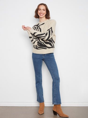 The ribbed cuffs and hem of this sweater ensure a snug fit while maintaining elegance and comfort. By Charlie B.