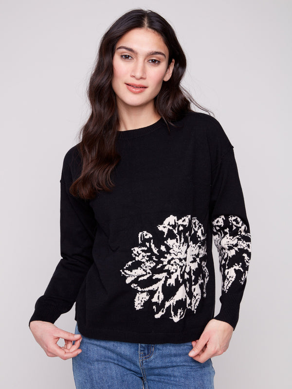 Black sweater showcasing a relaxed fit with intricate jacquard floral design, perfect for stylish comfort by Charlie B.