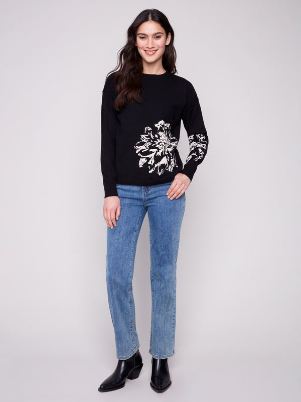 Elegant black sweater highlighted by a crew neck and detailed floral jacquard pattern for a chic look by Charlie B.