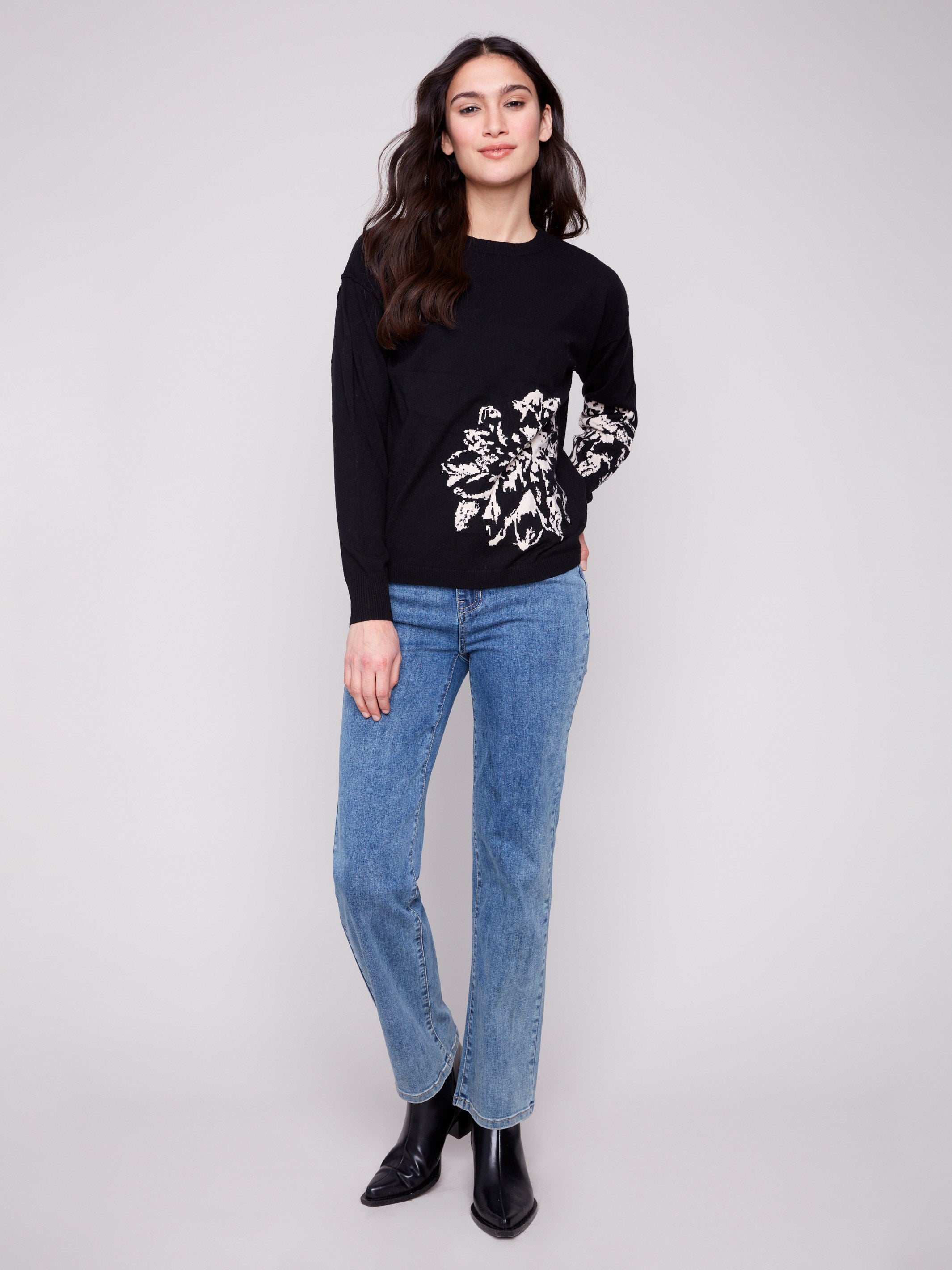 Stylish black sweater featuring a crew neckline and beautiful jacquard details, offering timeless elegance by Charlie B.