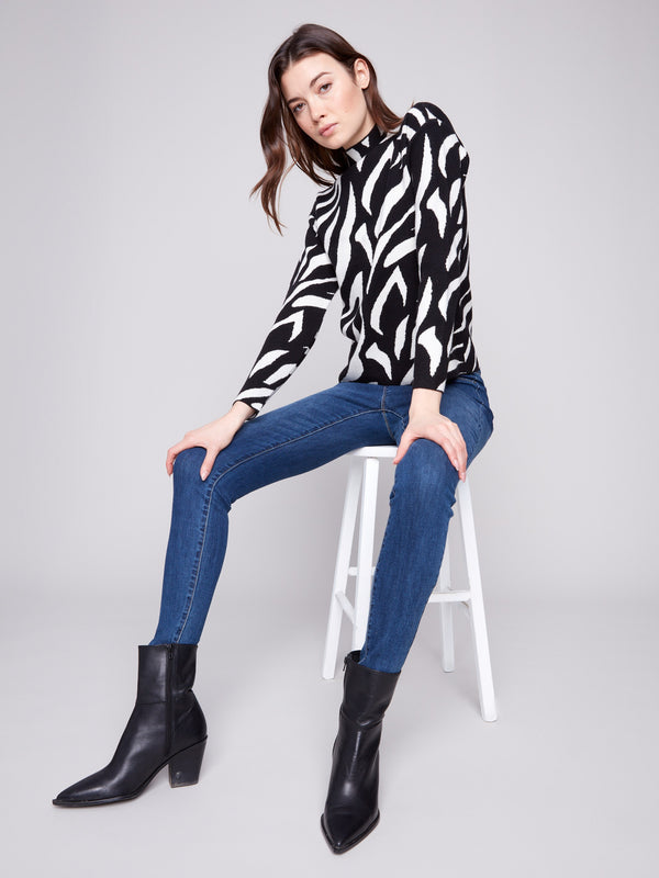 Stylish black and white jacquard sweater with long sleeves, perfect for a modern yet classic look by Charlie B.