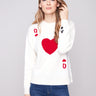 White plush knit sweater with a ribbed hem, showcasing red and black graphics by Charlie B.