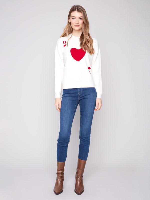 Plush knit sweater in white featuring drop shoulders and Queen of Hearts design by Charlie B.