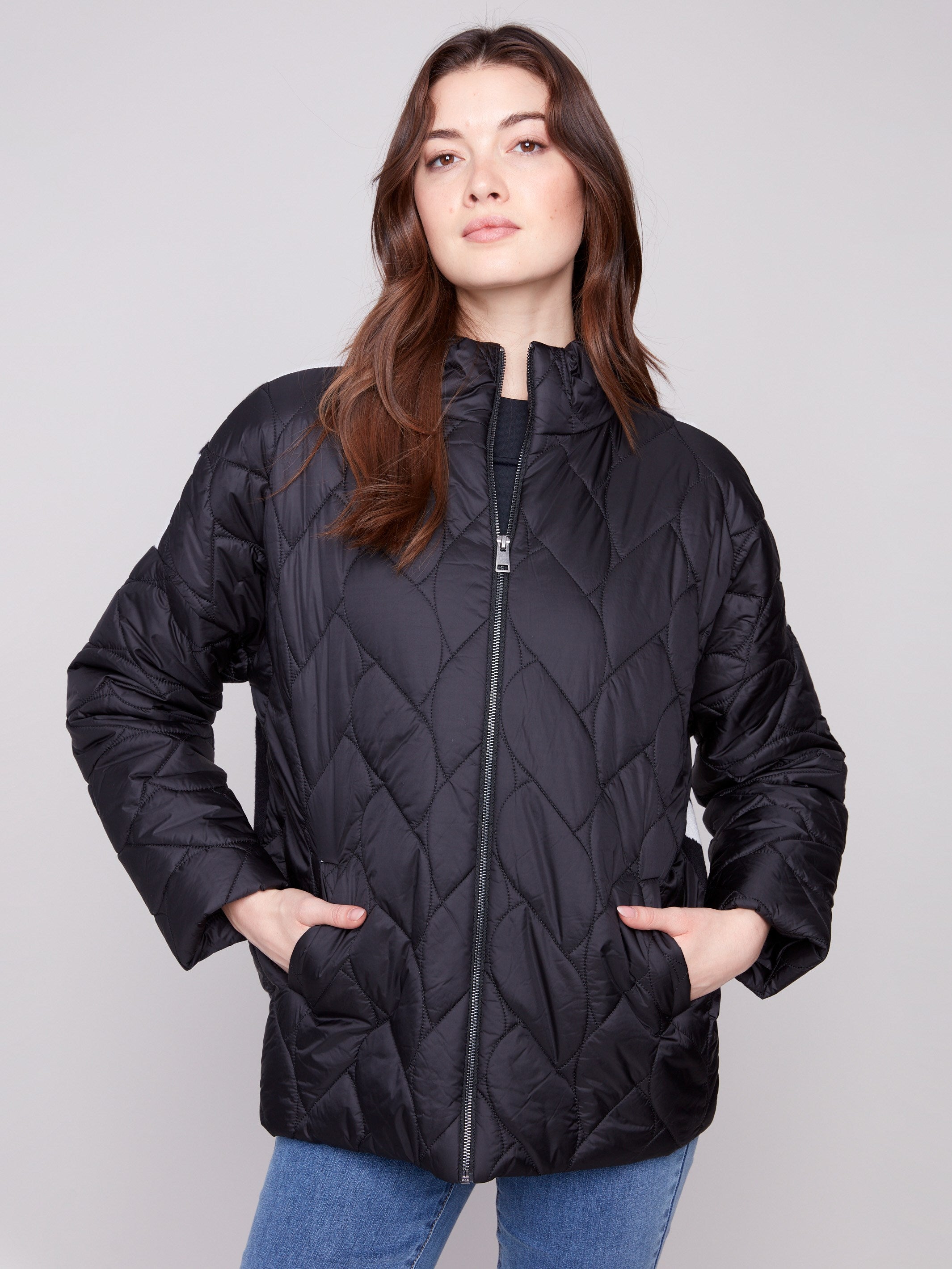 Black quilted puffer jacket featuring a stylish drop shoulder design and zip front closure by Charlie B.