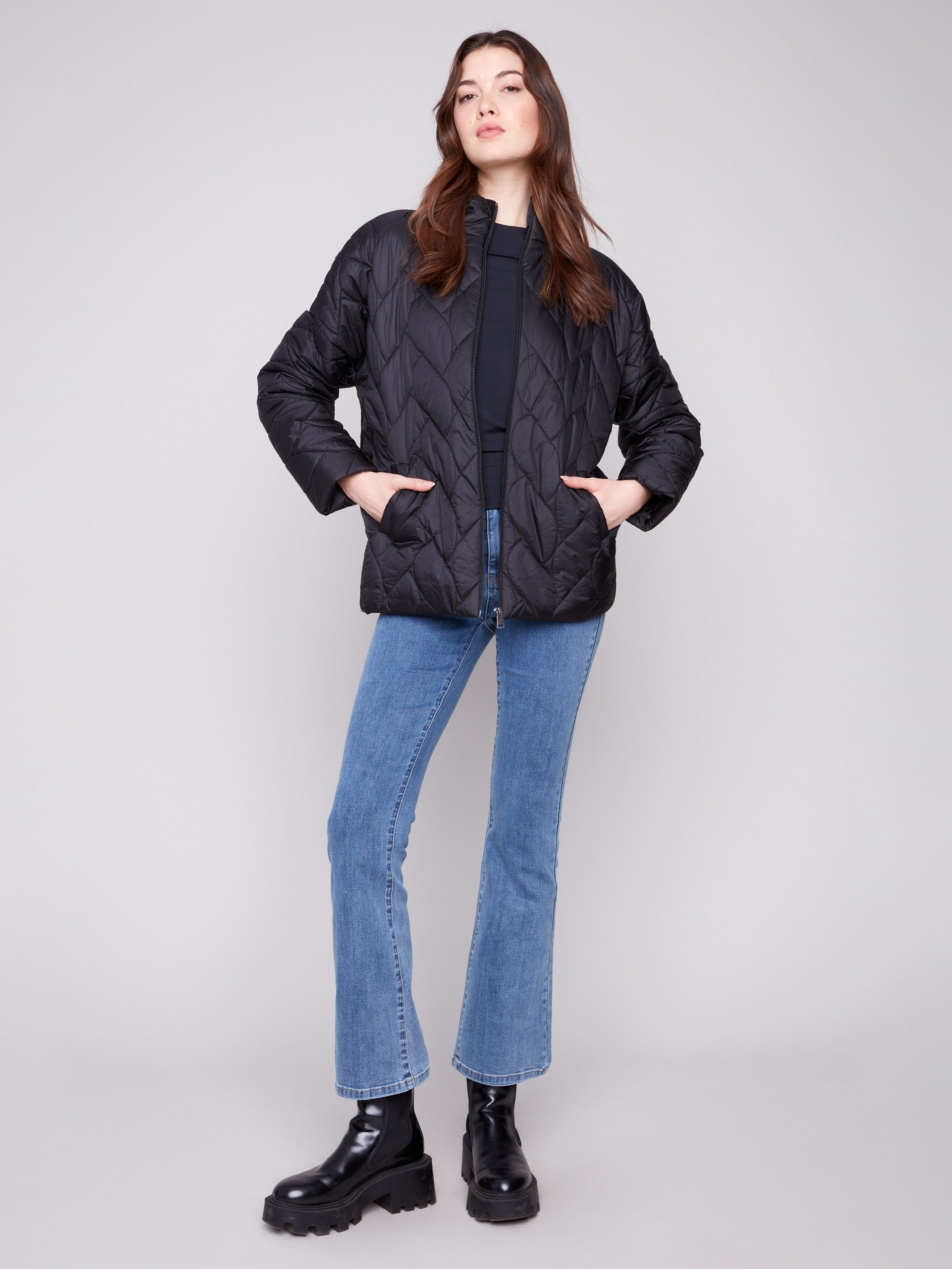 Fashionable black puffer jacket with practical welt pockets and a modern look by Charlie B.
