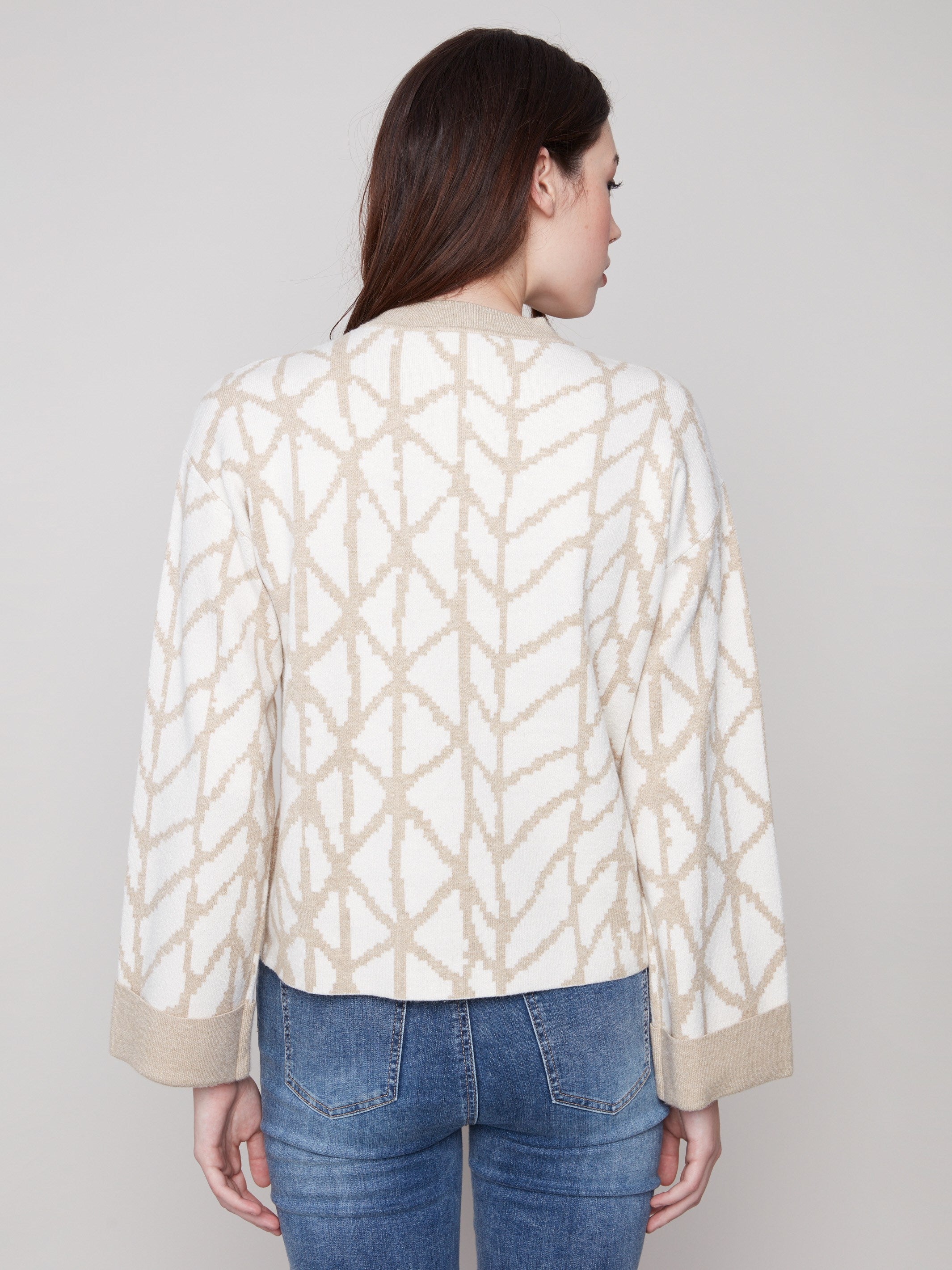 Elegant ecru sweater with a relaxed fit and striking geometric jacquard pattern for effortless style by Charlie B.