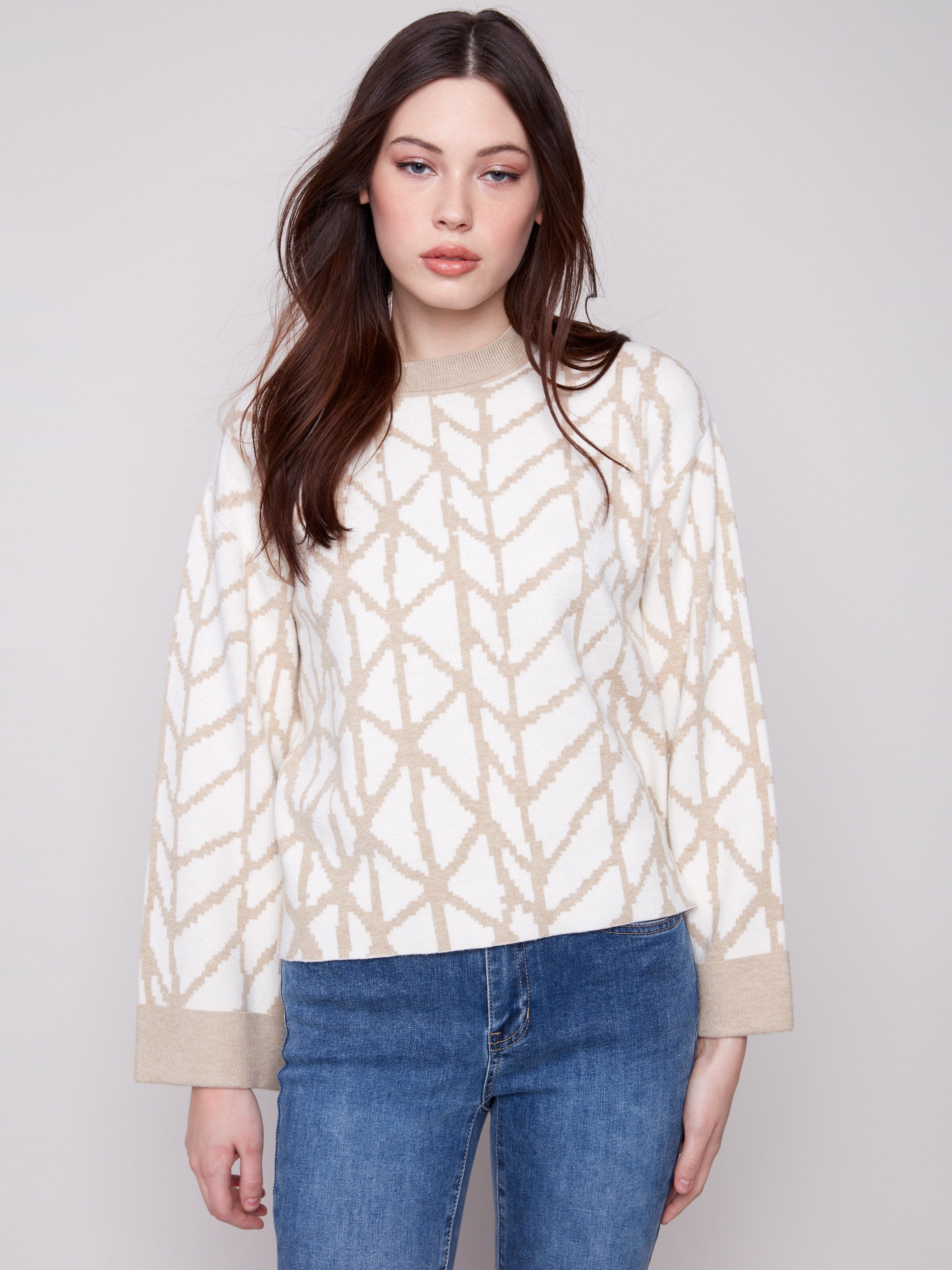 Chic ecru sweater with crew neckline and eye-catching jacquard pattern, adding a modern touch to your look by Charlie B.