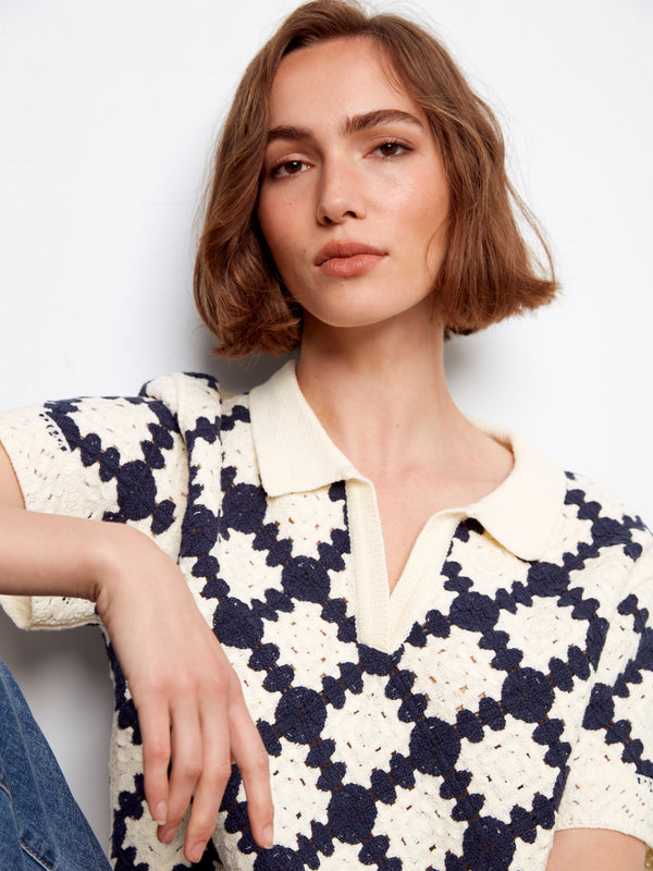 The crochet design of this navy and cream top is enhanced by a geometric pattern, adding charm to the piece by Charlie B.
