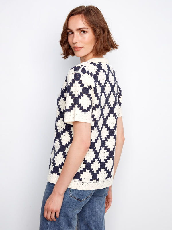 Featuring short sleeves, this navy and cream crochet top is adorned with a striking geometric motif for added flair by Charlie B.