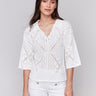 White sweater featuring a classic Johnny collar by Charlie B.