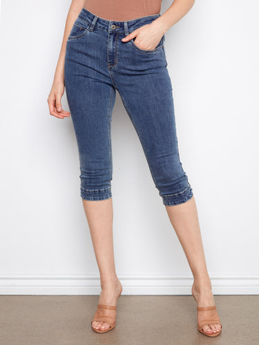 These medium blue capri jeans showcase a trendy slim fit and stretch denim, ensuring ease of movement by Charlie B.