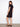 Classic knee-length black dress offering both style and functionality with its side pockets by Charlie B.