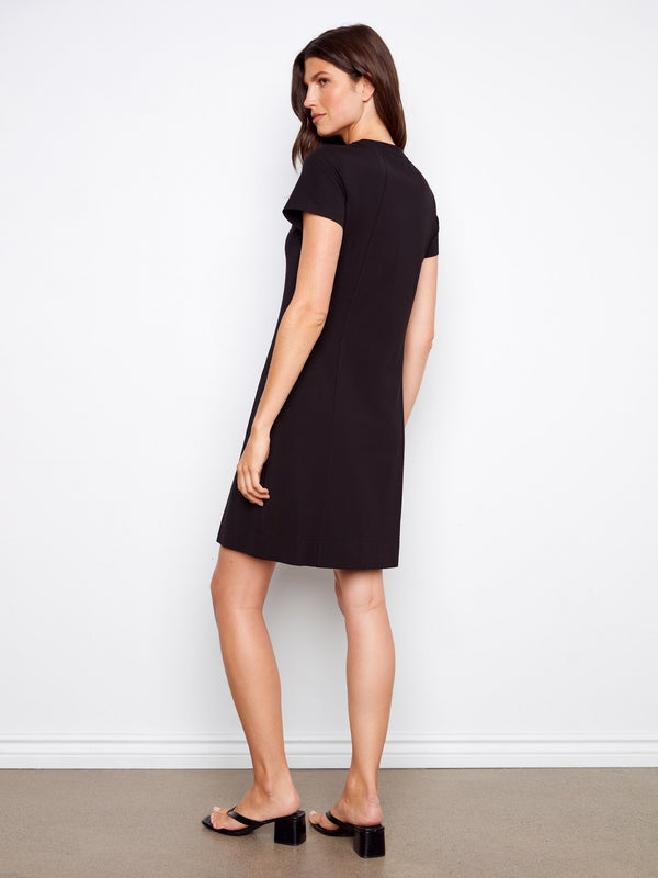 Classic knee-length black dress offering both style and functionality with its side pockets by Charlie B.