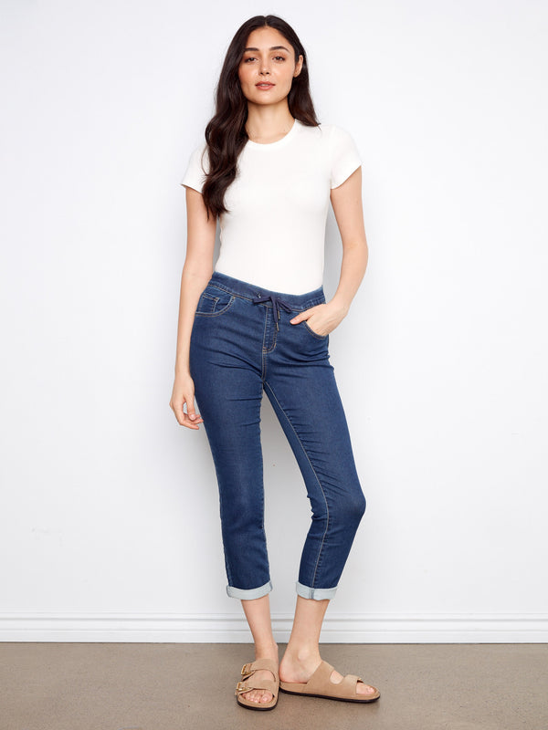 Indigo knit denim jogger pants showcasing a five-pocket design and cropped length for versatile styling by Charlie B.