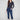 Indigo denim jogger pants featuring a slim leg and elastic waistband, paired with rolled cuffs for a chic look by Charlie B.