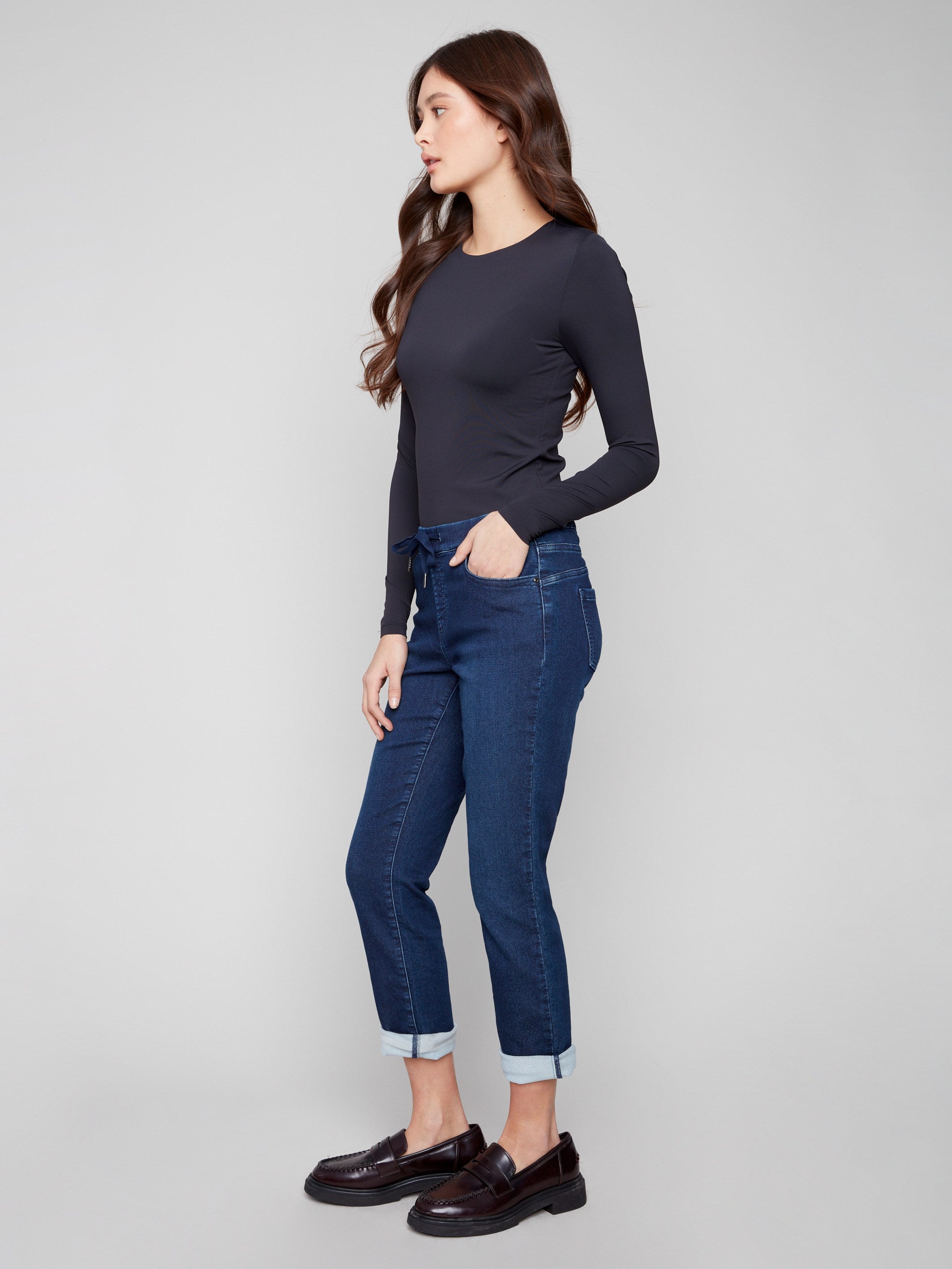 These indigo denim jogger pants include a five-pocket design and rolled cuffs, combining style and functionality by Charlie B.