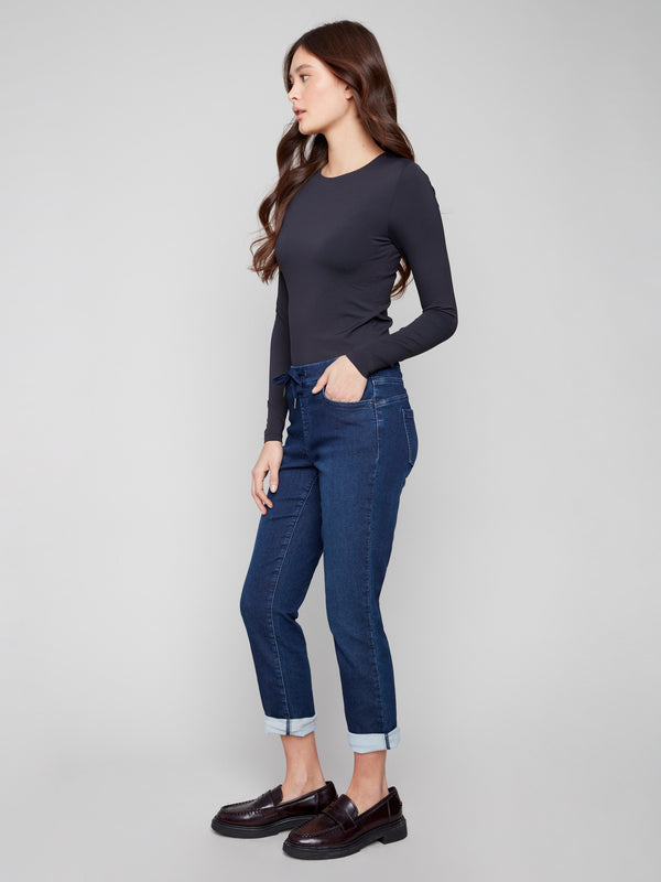These indigo denim jogger pants include a five-pocket design and rolled cuffs, combining style and functionality by Charlie B.