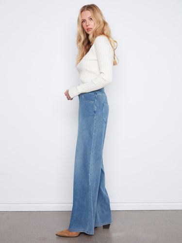 Medium blue denim pants showcasing a stylish 5-pocket design, ideal for carrying essentials effortlessly by Charlie B.