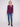Elegant berry knit sweater with practical front pockets and a chic rounded hem by Charlie B.