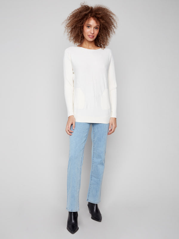 Long ribbed sleeves enhance the sophisticated look of this ecru knit sweater, offering both style and comfort by Charlie B.