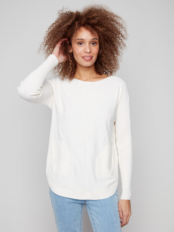 The rounded hem adds a touch of modernity to this classic ecru knit sweater, ideal for any wardrobe by Charlie B.