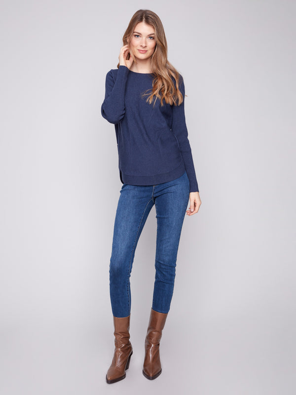 Stylish heather denim sweater designed with convenient front pockets and a flattering fit for everyday wear by Charlie B.