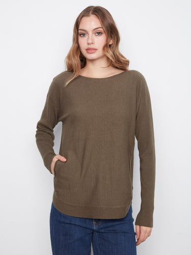 With its rounded hem, this olive sweater offers a flattering silhouette that pairs well with jeans or skirts. By Charlie B.