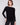 Black knit sweater featuring a stylish boat neck design and elegant front pockets by Charlie B.