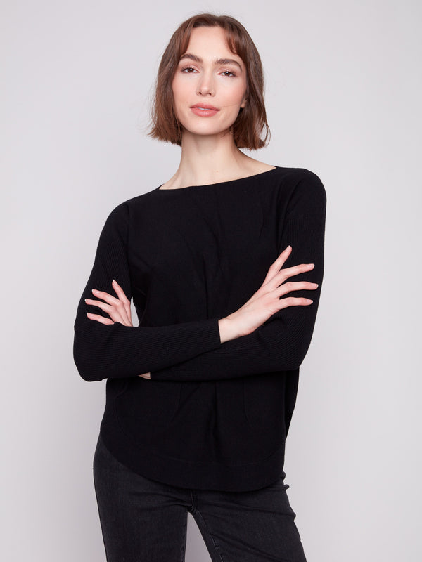 Elegant black knit sweater showcasing long ribbed sleeves for a cozy and chic look by Charlie B.