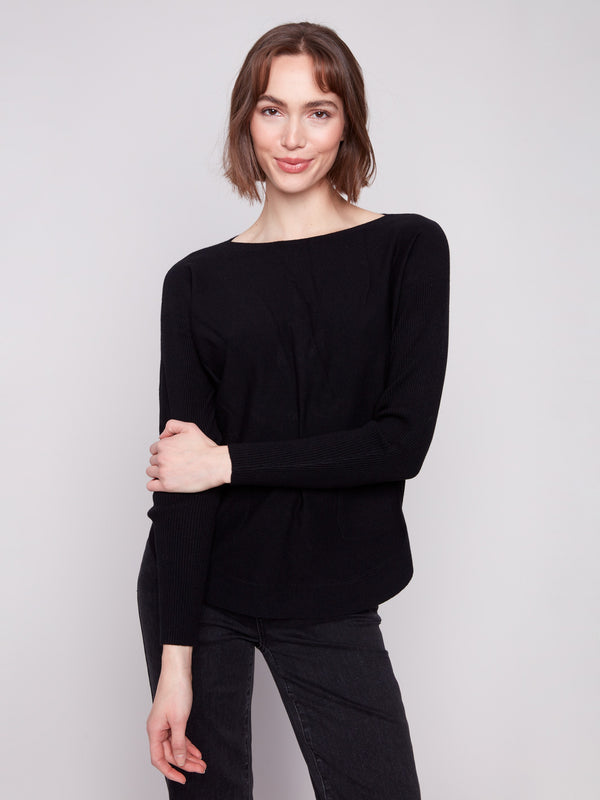 Chic black knit sweater with practical front pockets, perfect for everyday wear by Charlie B.