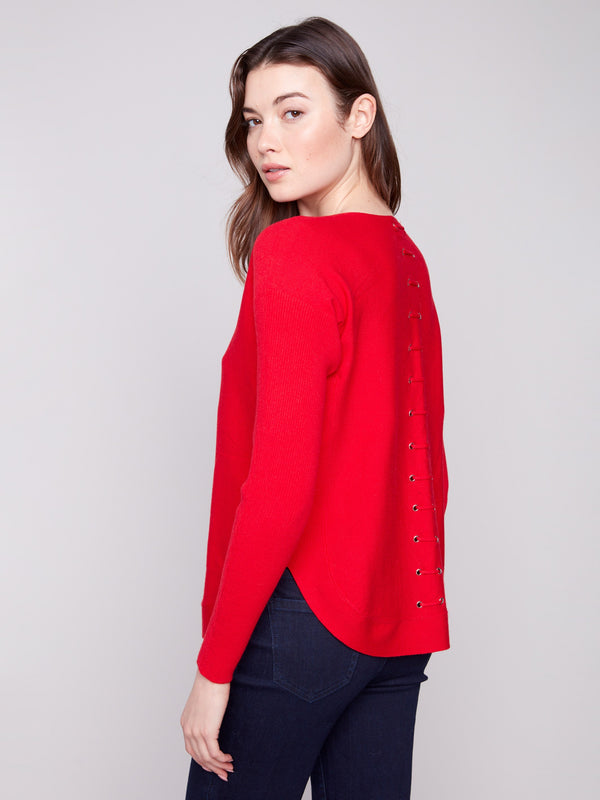 Crimson sweater showcasing an elegant design with rounded hem and lace-up accents by Charlie B.
