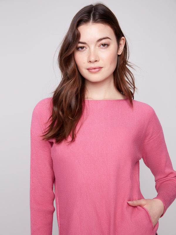 Chic pink knit sweater with convenient front pockets, blending fashion with functionality by Charlie B.