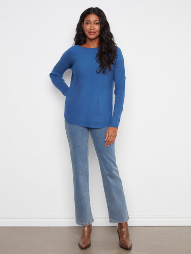 Designed with a rounded hem, this blue sweater offers both comfort and style for everyday wear. By Charlie B.