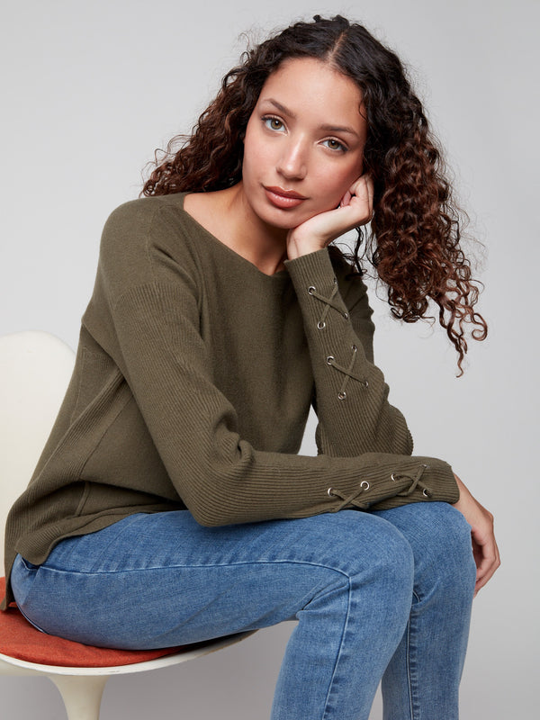 Cozy spruce knit sweater with rounded hem design, ideal for layering during cooler seasons by Charlie B.