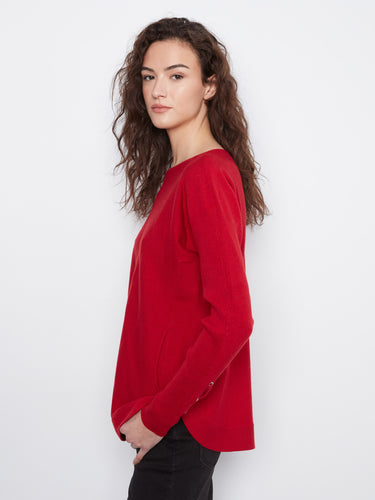 This red sweater showcases a rounded hem, providing both comfort and style for everyday wear by Charlie B.