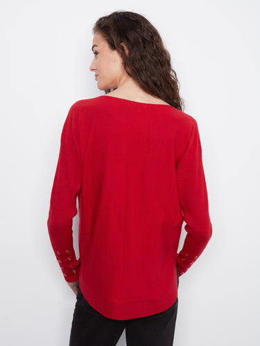 Designed with practical side pockets, this red sweater combines functionality with fashion effortlessly by Charlie B.
