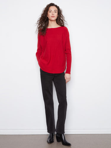 Featuring long ribbed sleeves, this red sweater ensures warmth while maintaining a sleek silhouette by Charlie B.