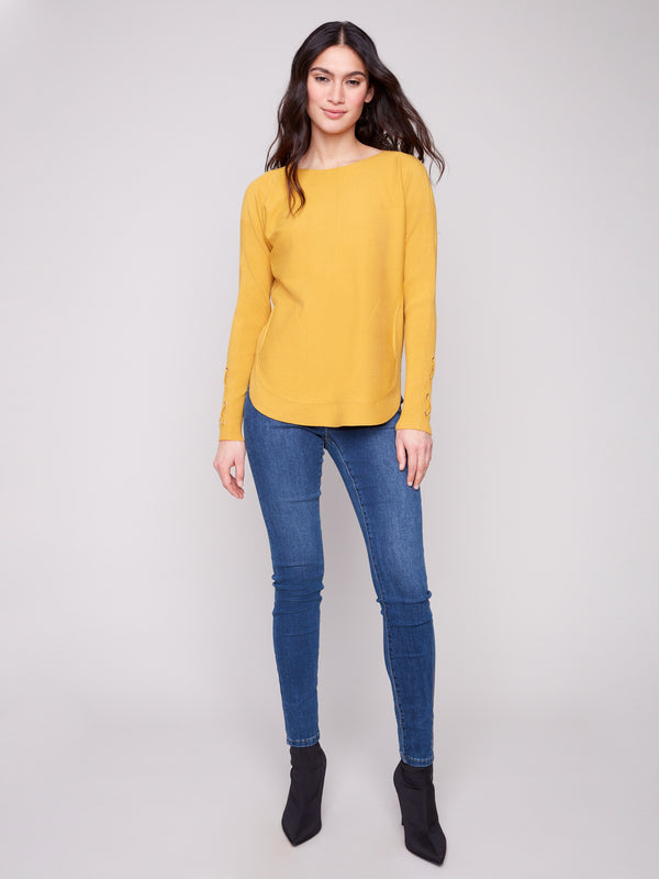 Chic honey knit sweater with convenient side pockets for added functionality by Charlie B.