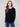 Black knit sweater featuring a stylish boat neck and long ribbed sleeves, perfect for a chic look by Charlie B.