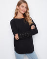 Black knit sweater featuring a boat neck and stylish rounded hem, perfect for casual outings by Charlie B.