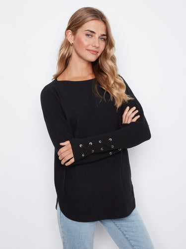 Black knit sweater featuring a boat neck and stylish rounded hem, perfect for casual outings by Charlie B.