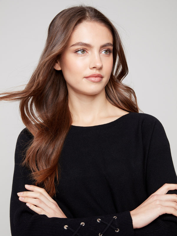 Elegant black knit sweater with lace-up cuff detail adding a touch of sophistication to your wardrobe by Charlie B.