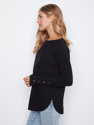 Chic black sweater showcasing intricate lace-up cuff details, adding flair to any outfit by Charlie B.
